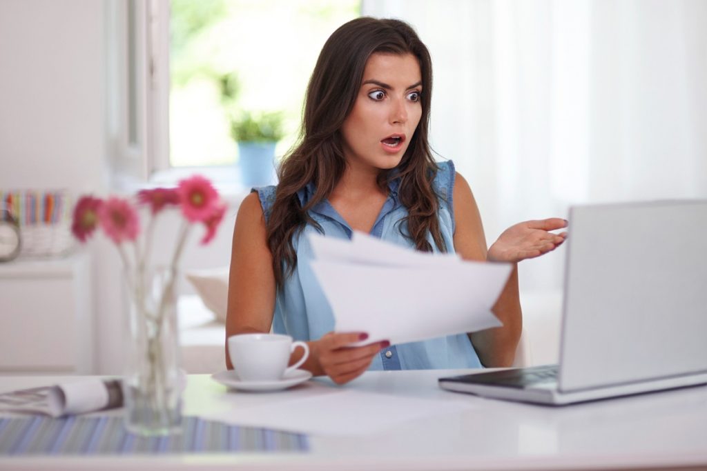 Courrier de notification de trop-perçu posé sur une table avec une calculatrice